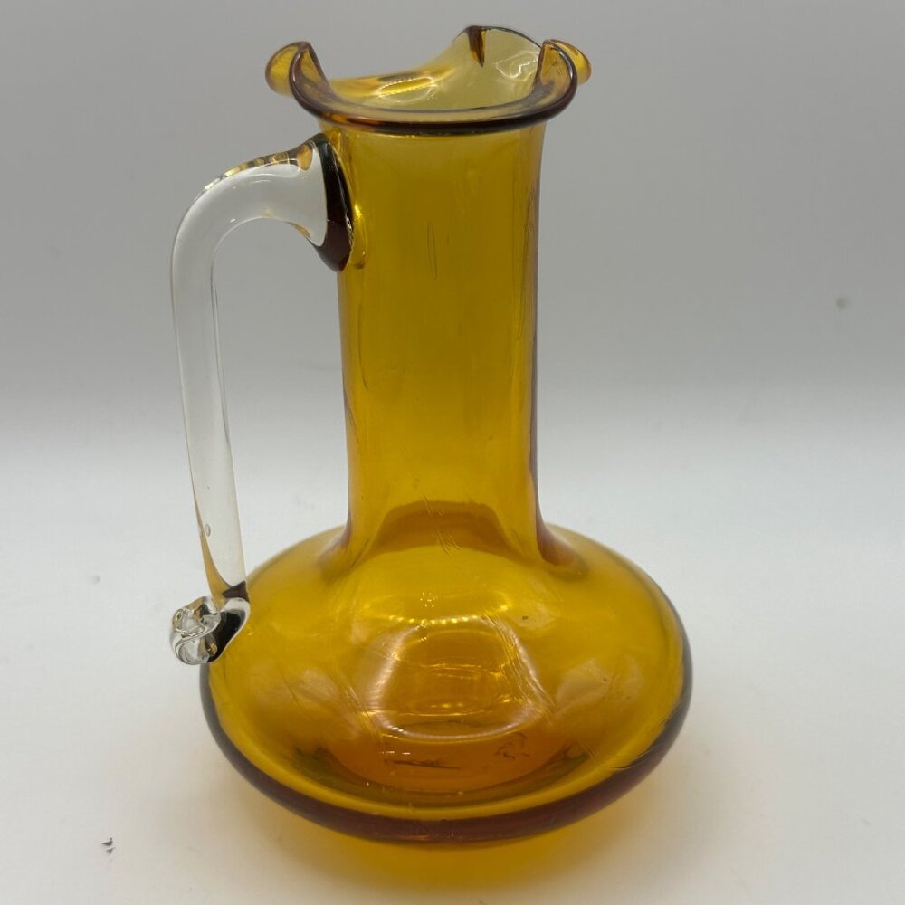 Unbranded hand blown amber with clear handle 4” miniature glass pitcher